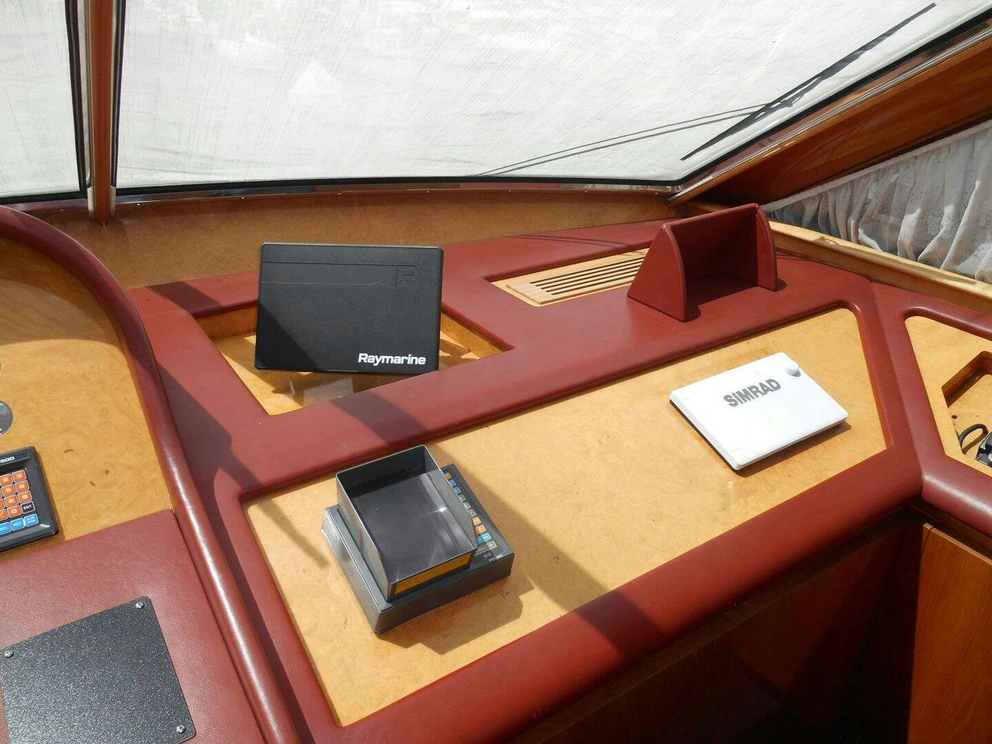 a group of cell phones on a table aboard LADY C Yacht for Sale
