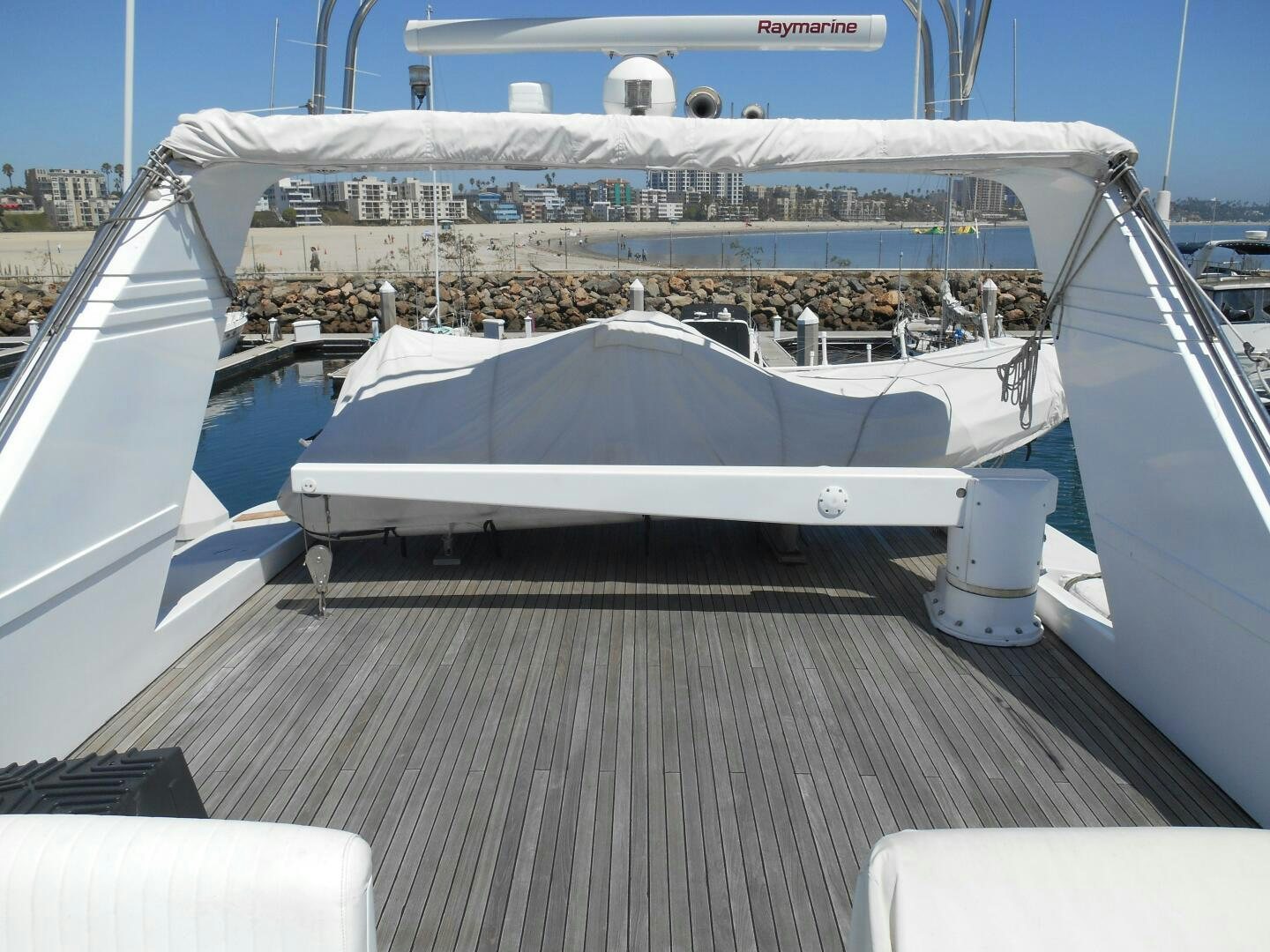 a deck with a large cruise ship in the background aboard LADY C Yacht for Sale