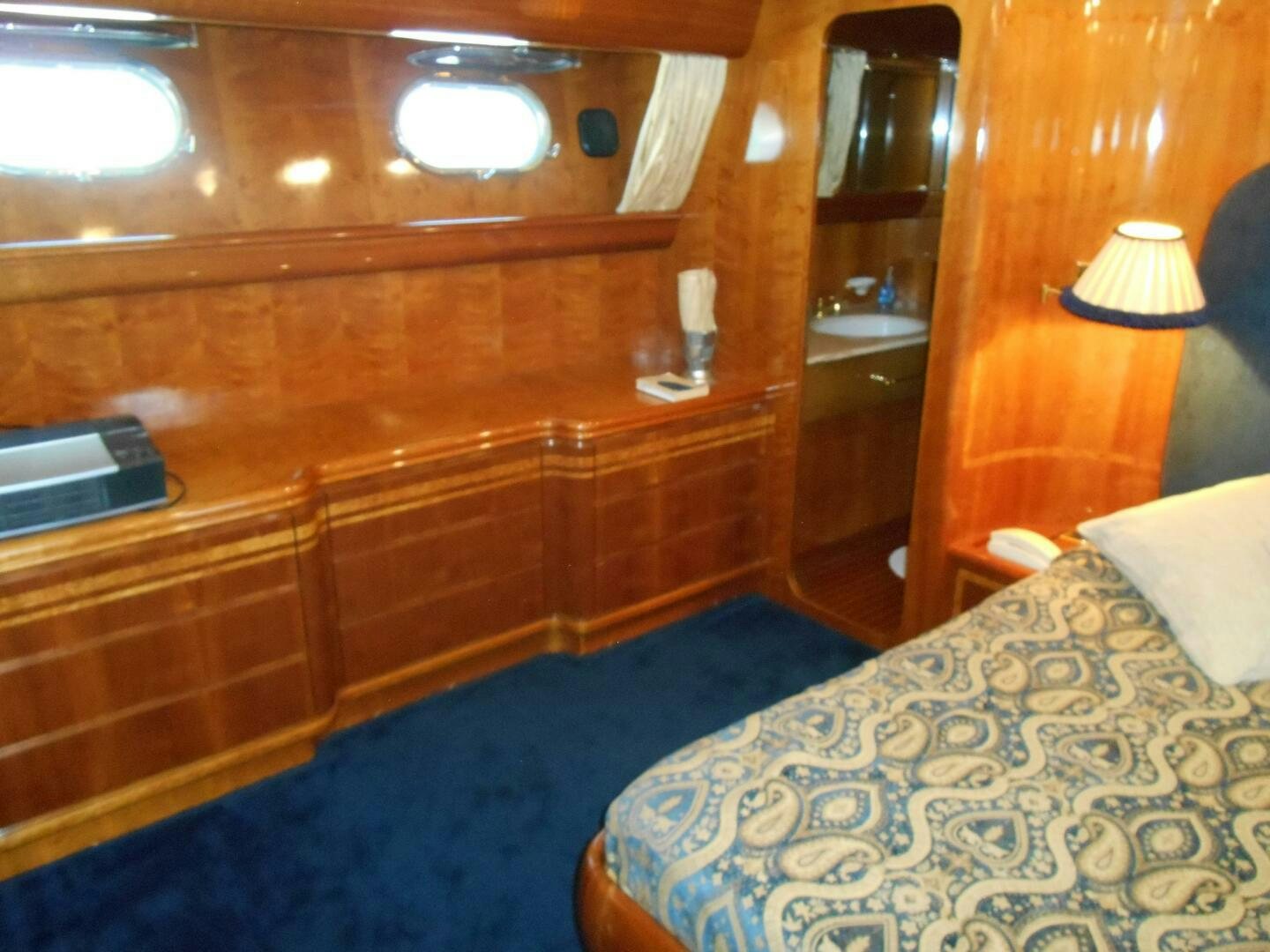 a room with a bed and a desk aboard LADY C Yacht for Sale