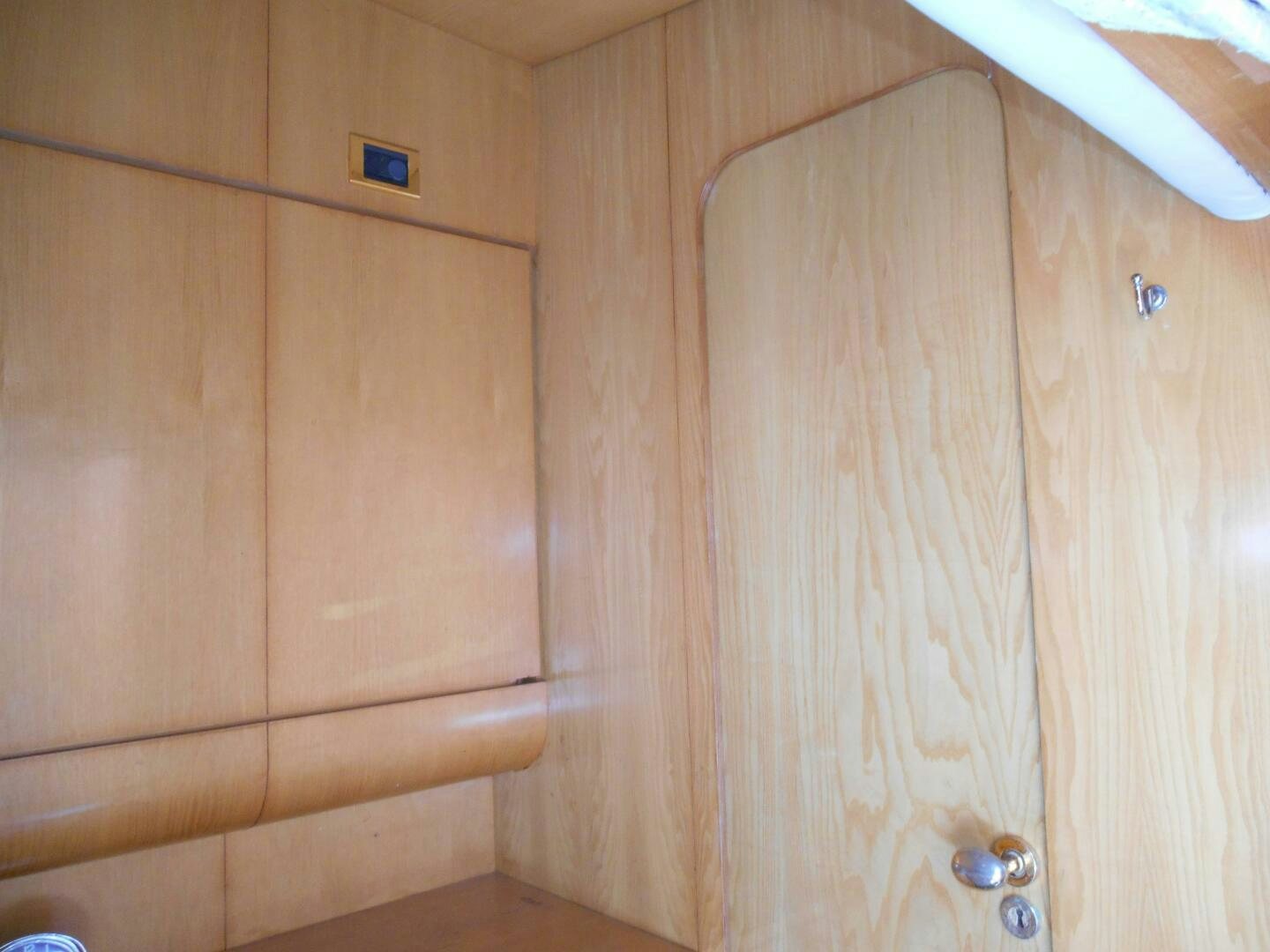 a wooden cabinet with a door aboard LADY C Yacht for Sale