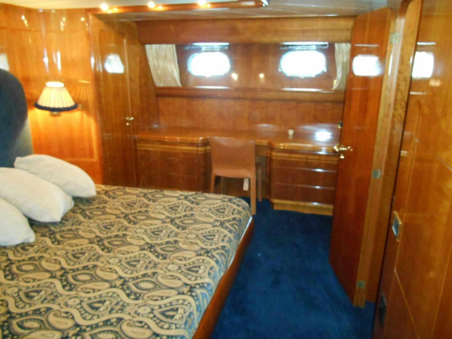 a room with a bed and a chair aboard LADY C Yacht for Sale