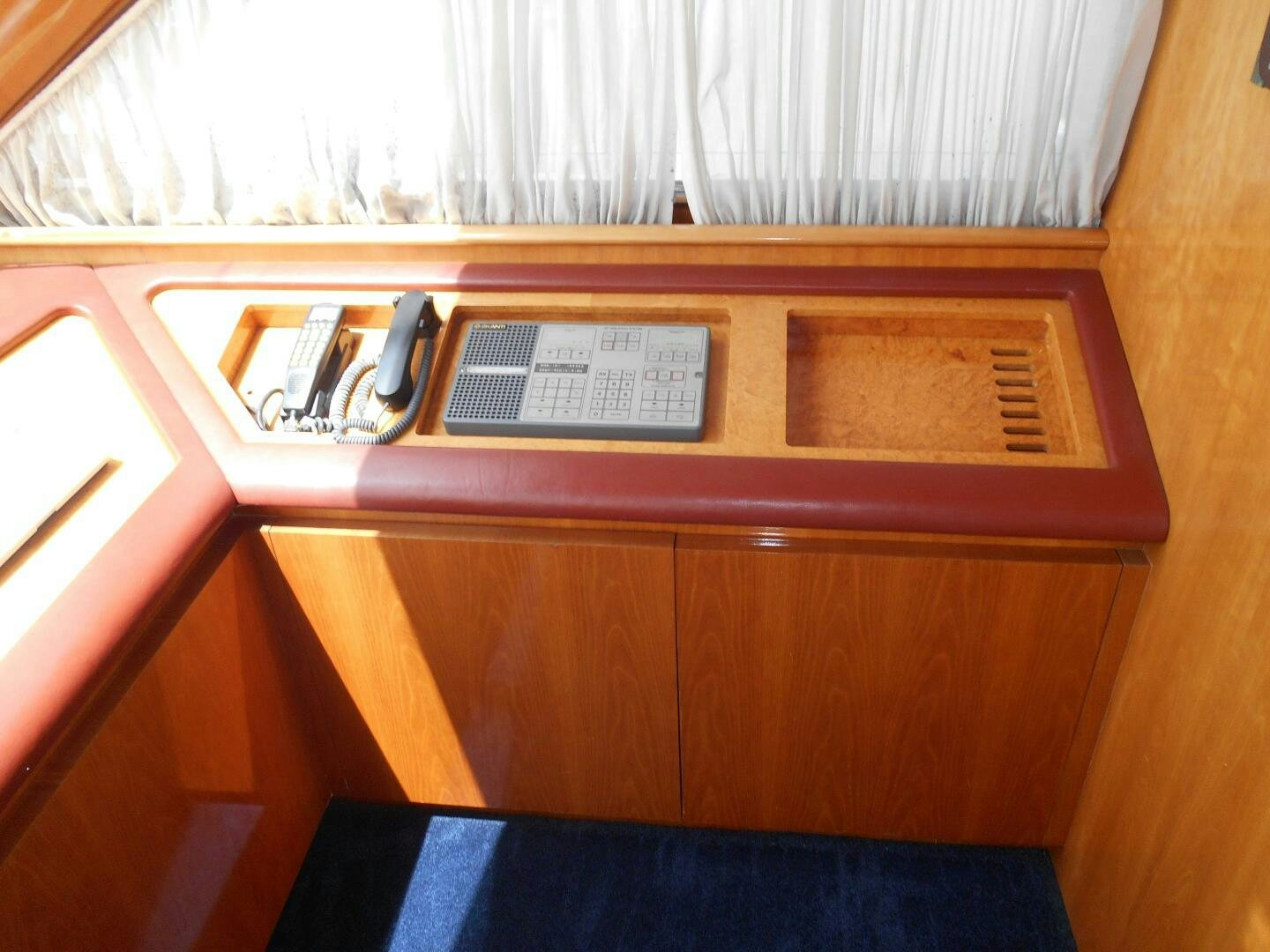 a wooden cabinet with a computer on it aboard LADY C Yacht for Sale