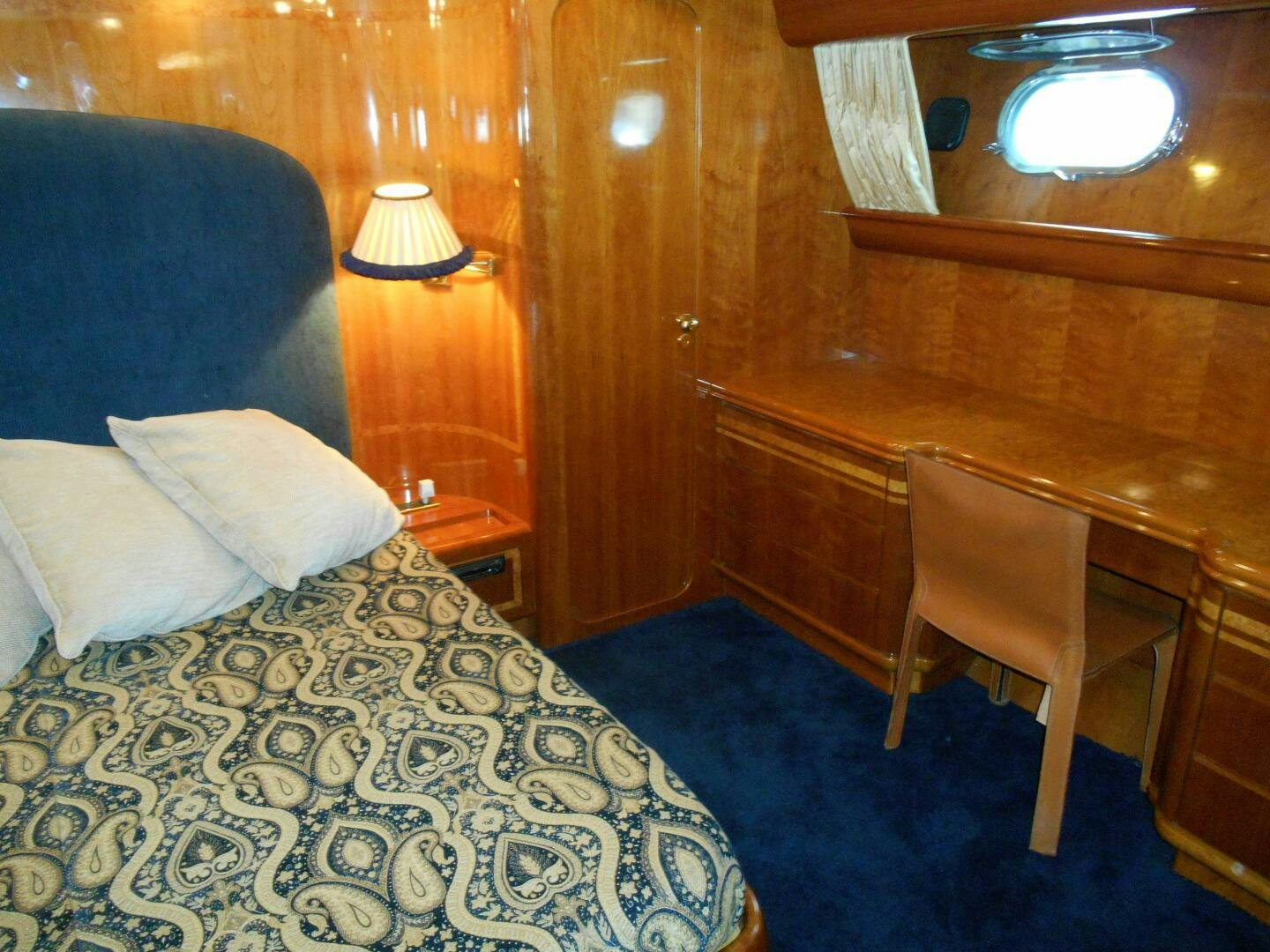 a bed with a blue blanket aboard LADY C Yacht for Sale