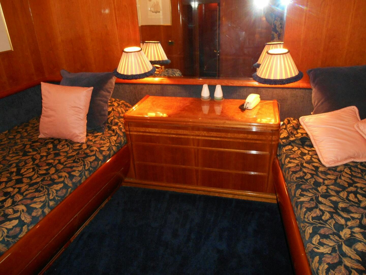 a bed with a wooden headboard aboard LADY C Yacht for Sale