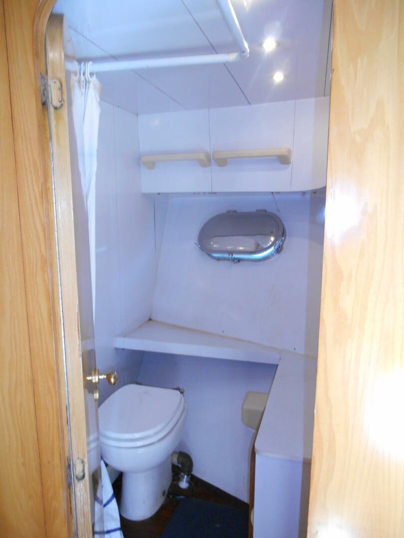 a small bathroom with a toilet aboard LADY C Yacht for Sale