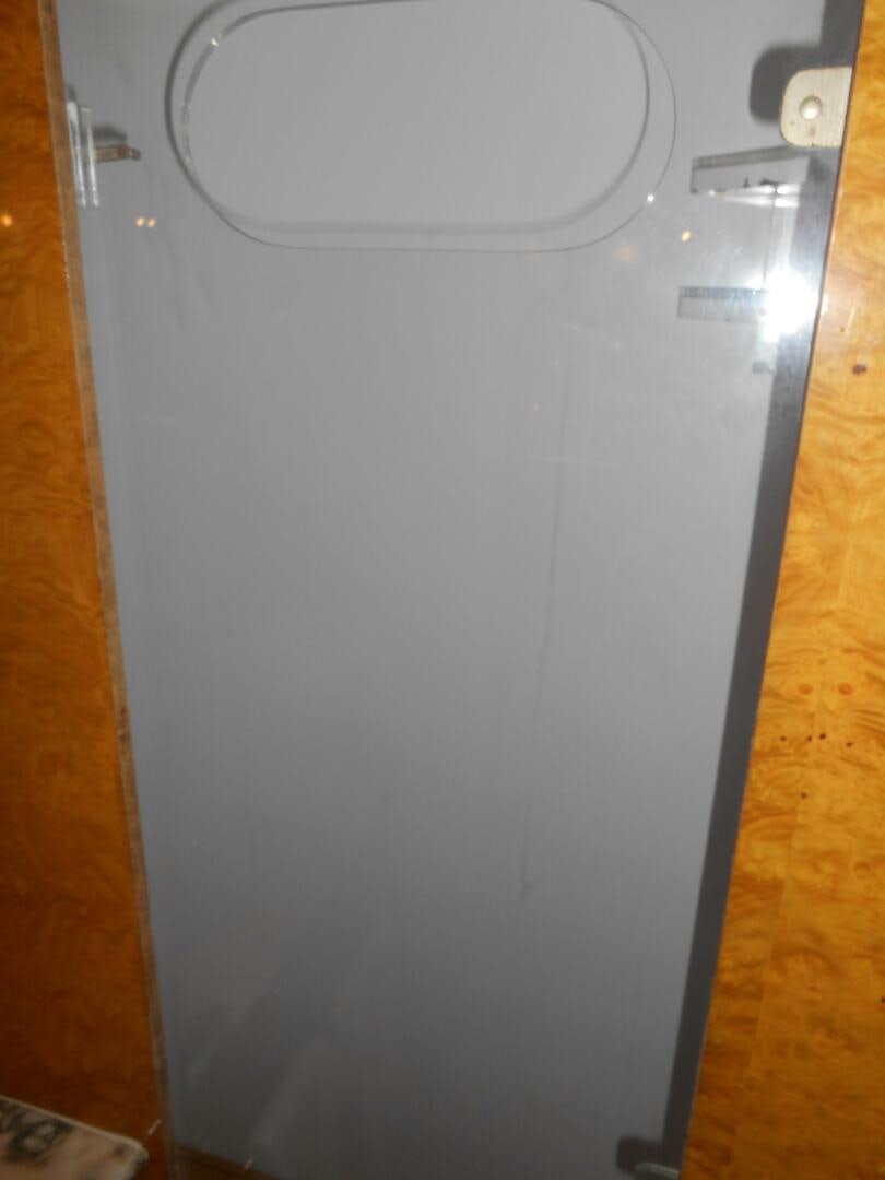 a white wall with a silver door aboard LADY C Yacht for Sale