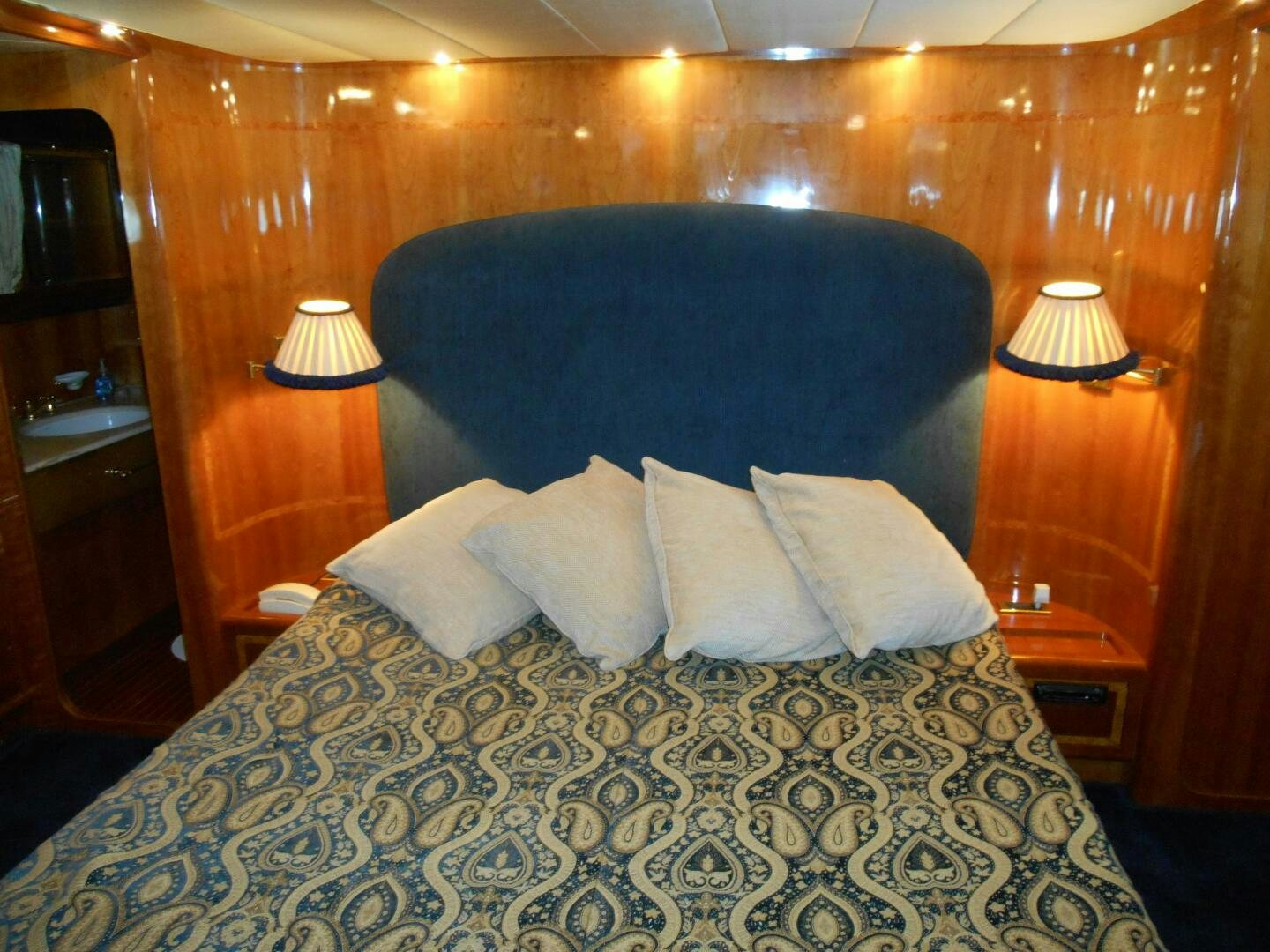 a bed with a blue comforter aboard LADY C Yacht for Sale