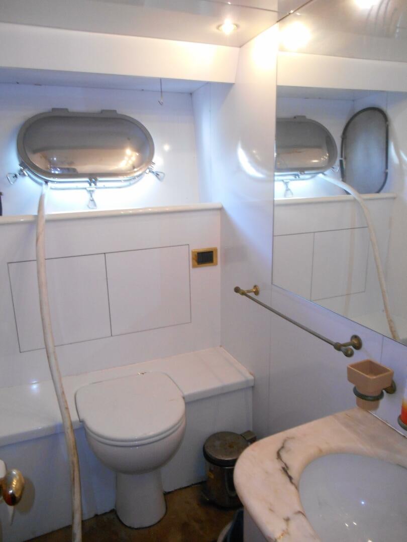 a bathroom with a toilet and a sink aboard LADY C Yacht for Sale