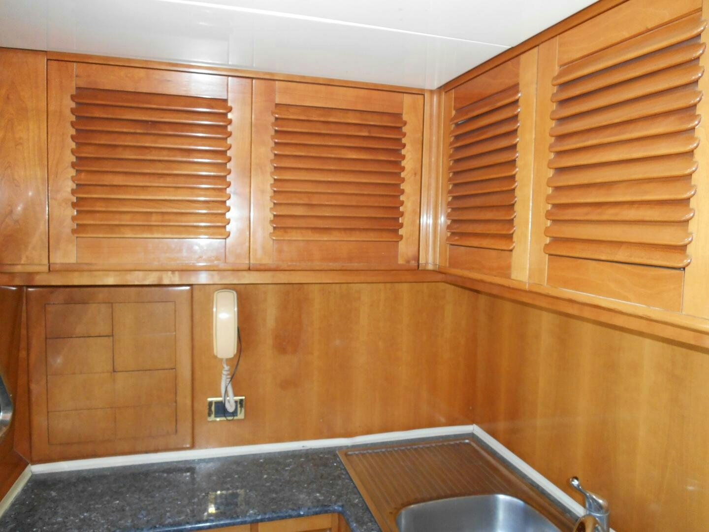 a wooden cabinet with a silver faucet aboard LADY C Yacht for Sale