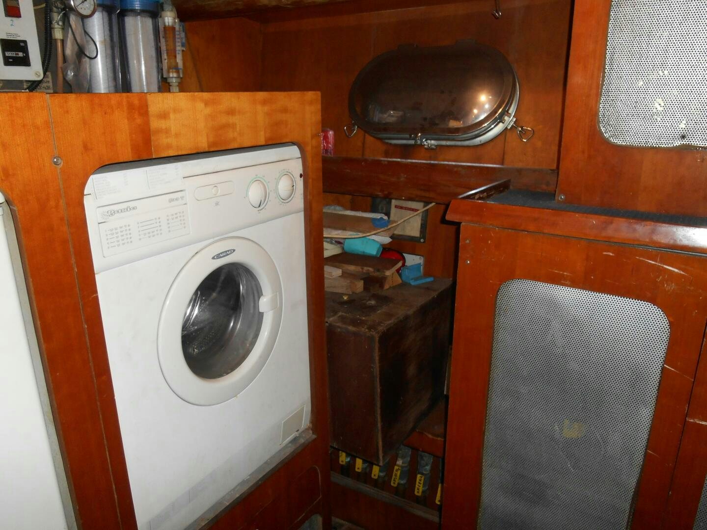 a small kitchen with a washing machine aboard LADY C Yacht for Sale