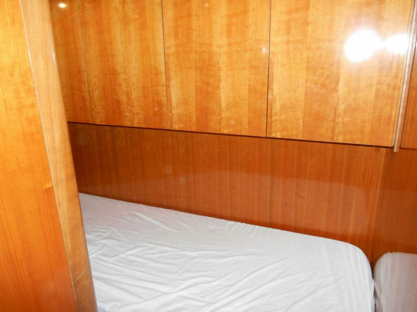 a bed with a wooden headboard aboard LADY C Yacht for Sale