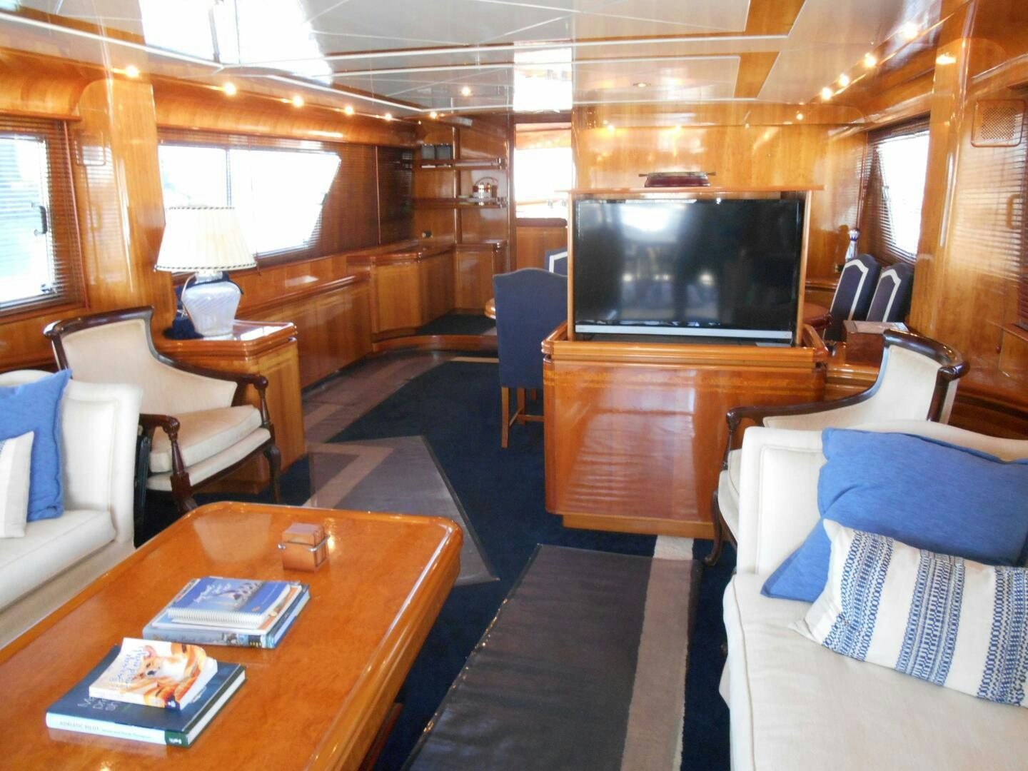a living room with a table and chairs aboard LADY C Yacht for Sale