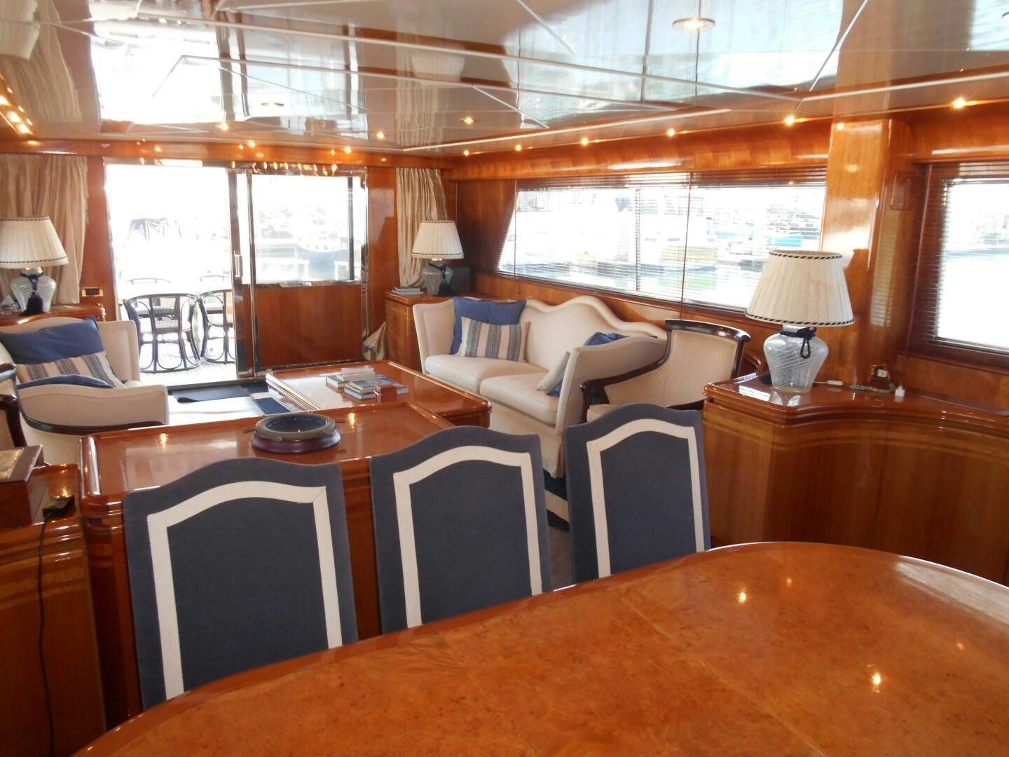 a large room with a table and chairs aboard LADY C Yacht for Sale