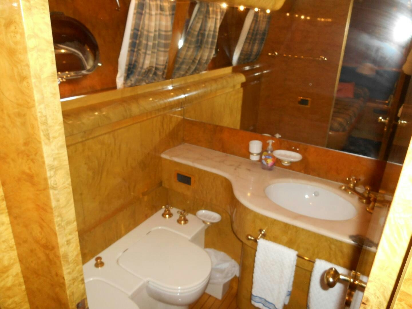 a bathroom with a large mirror aboard LADY C Yacht for Sale