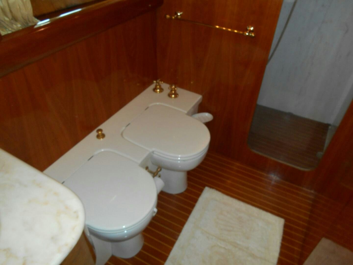 a bathroom with a toilet and a sink aboard LADY C Yacht for Sale