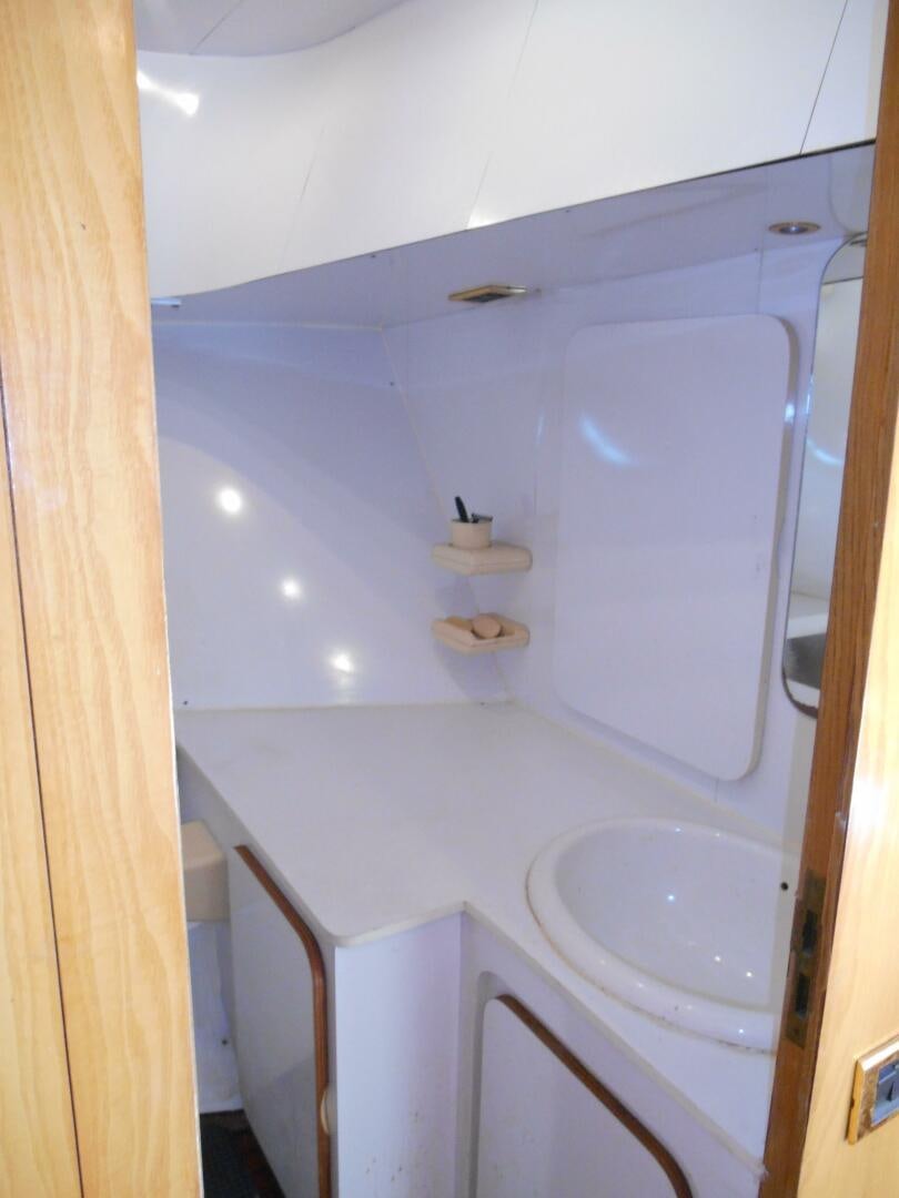a bathroom with a sink and a mirror aboard LADY C Yacht for Sale