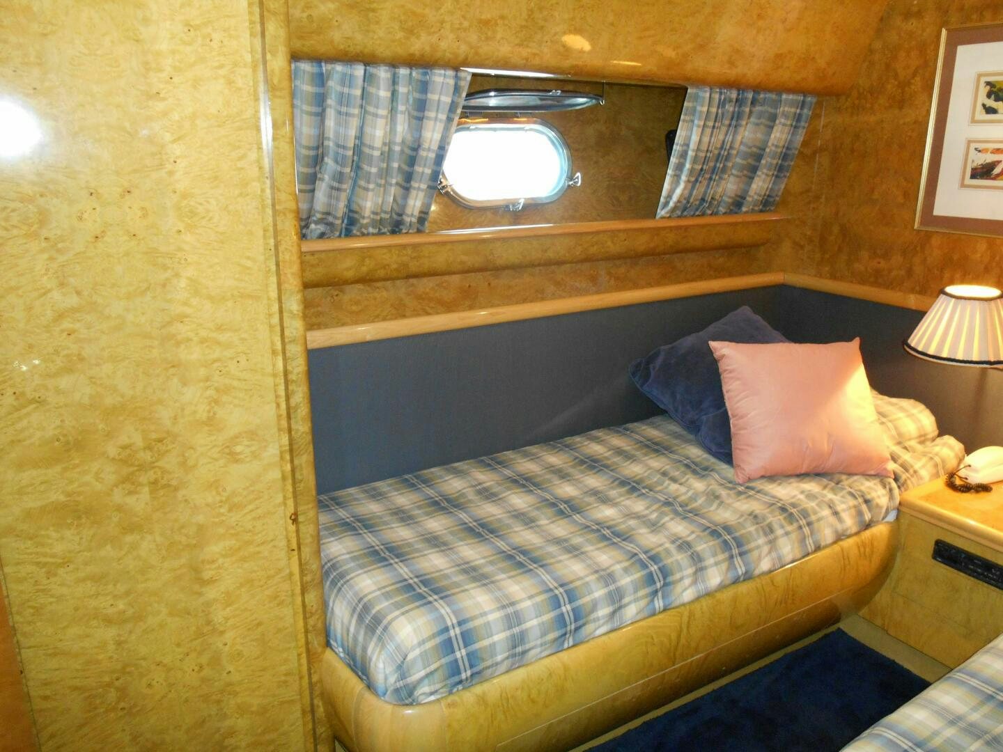 a bed with a blue comforter aboard LADY C Yacht for Sale