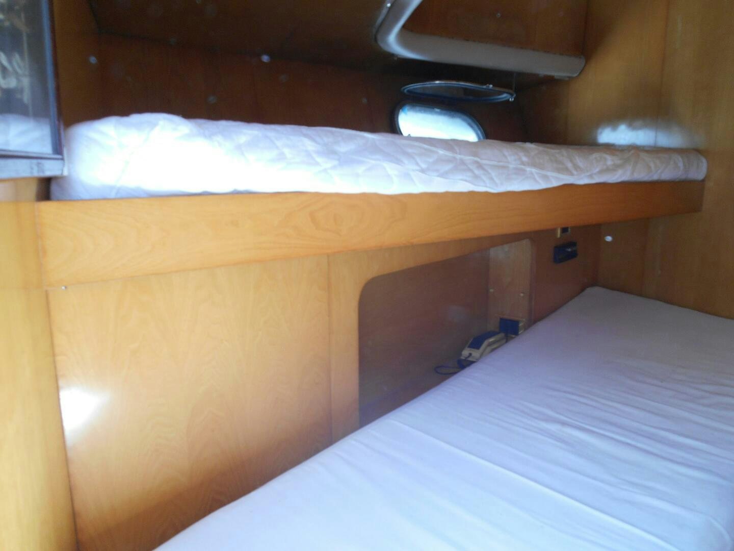 a bed with a white sheet aboard LADY C Yacht for Sale
