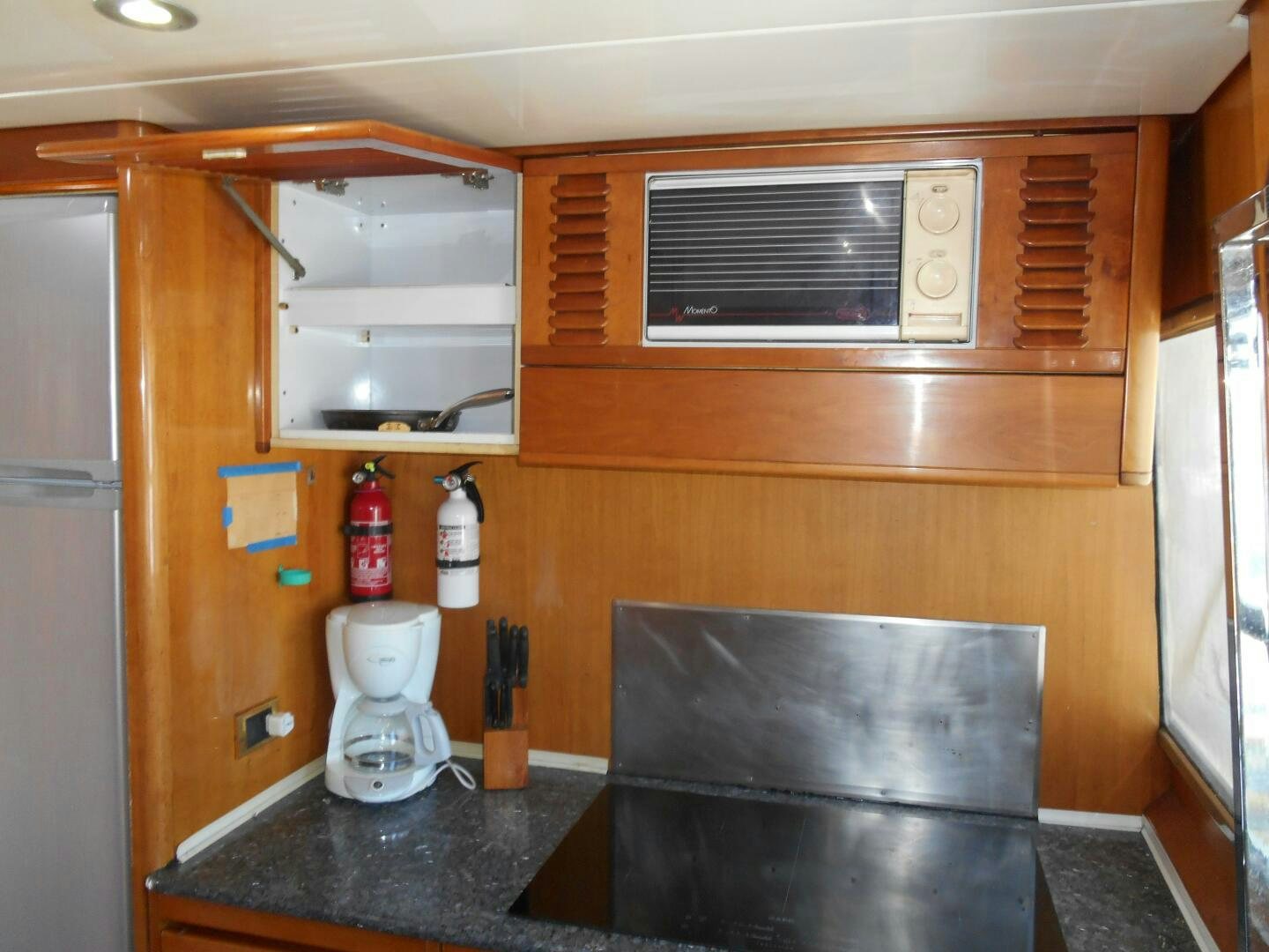 a kitchen with a black counter top aboard LADY C Yacht for Sale