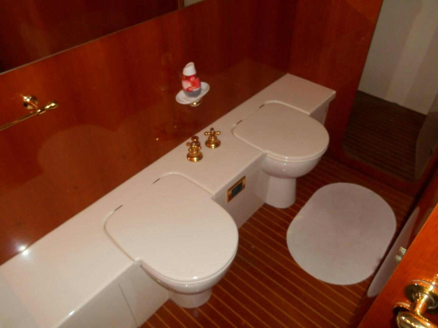 a bathroom with a toilet and a sink aboard LADY C Yacht for Sale