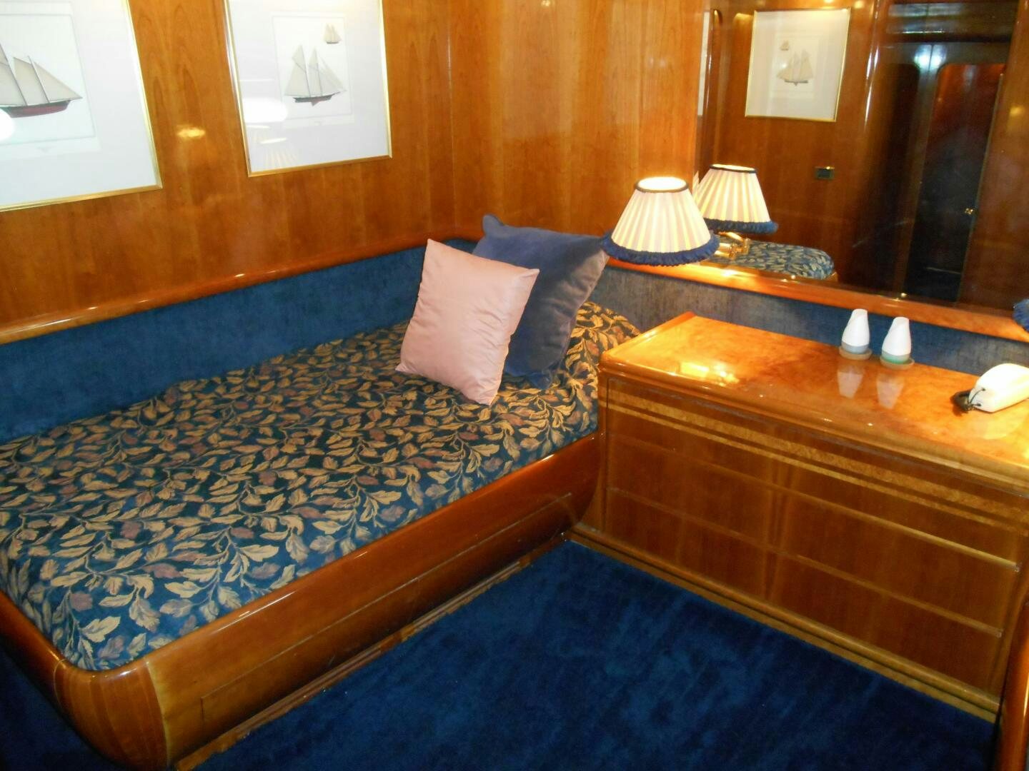 a bed with a blue comforter aboard LADY C Yacht for Sale