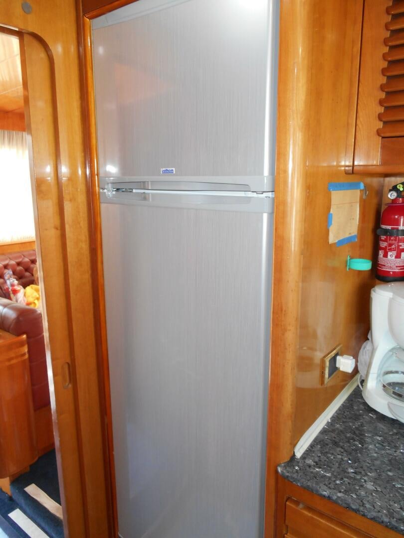 a refrigerator in a kitchen aboard LADY C Yacht for Sale