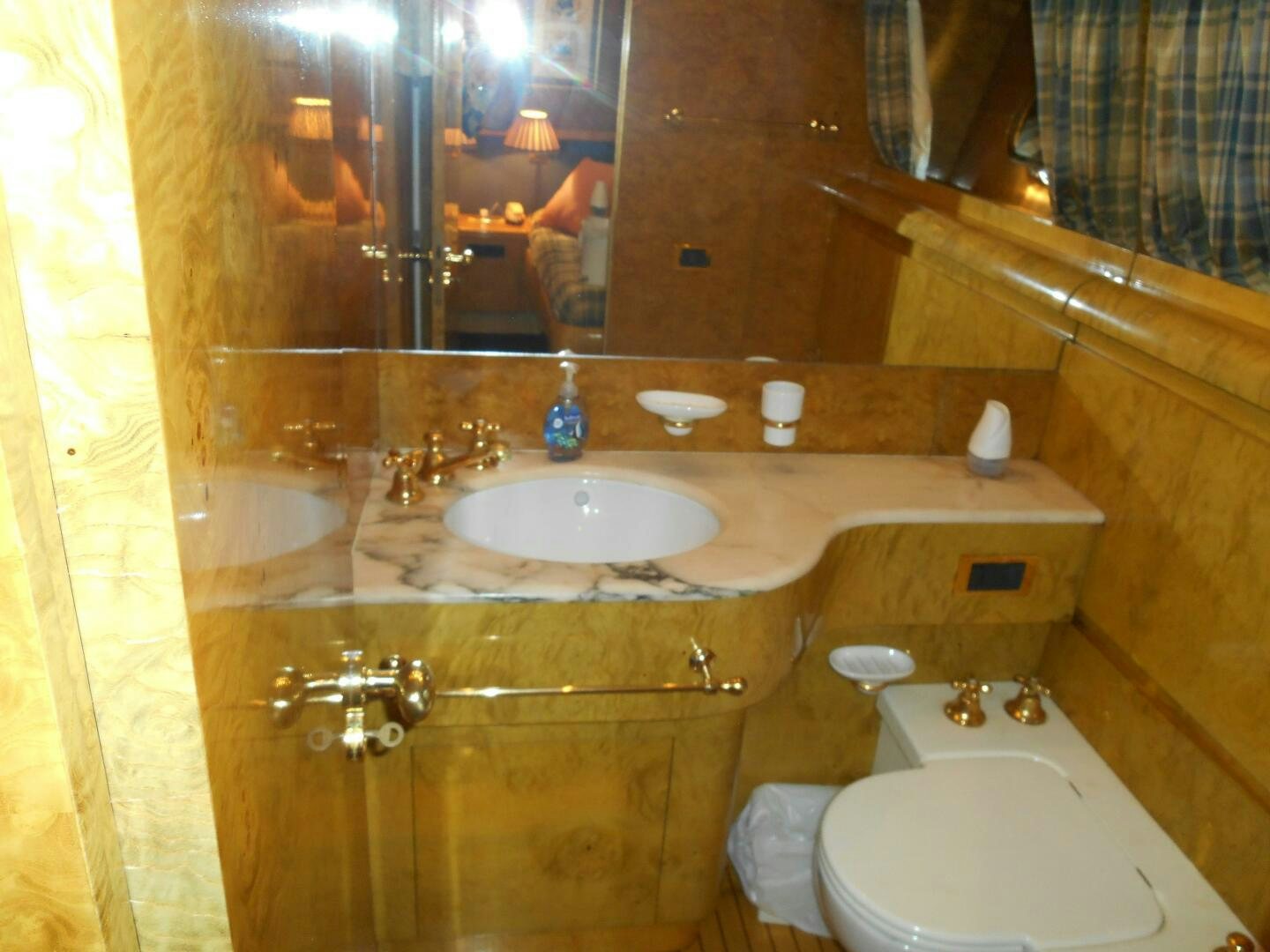a bathroom with a sink and a toilet aboard LADY C Yacht for Sale