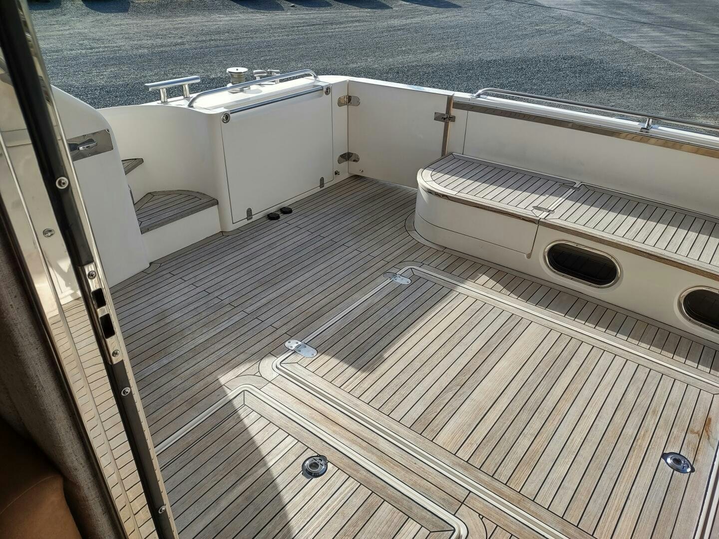 a deck with a deck and a boat on it aboard F66 Yacht for Sale