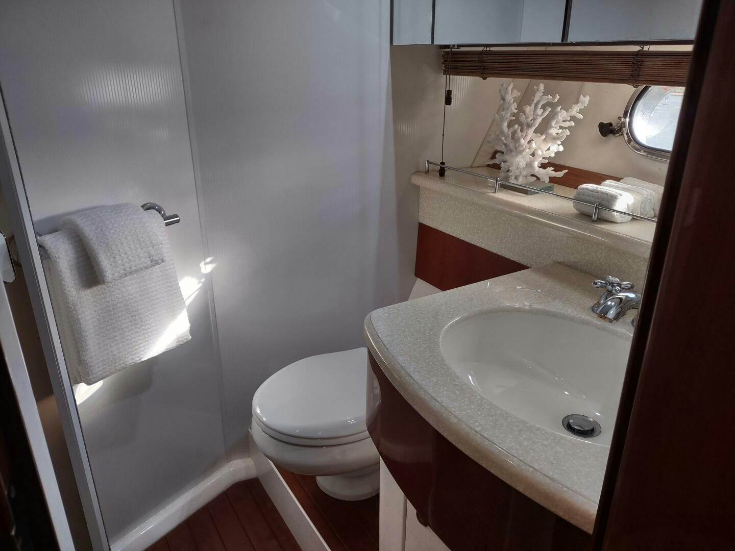 a bathroom with a sink toilet and a mirror aboard F66 Yacht for Sale