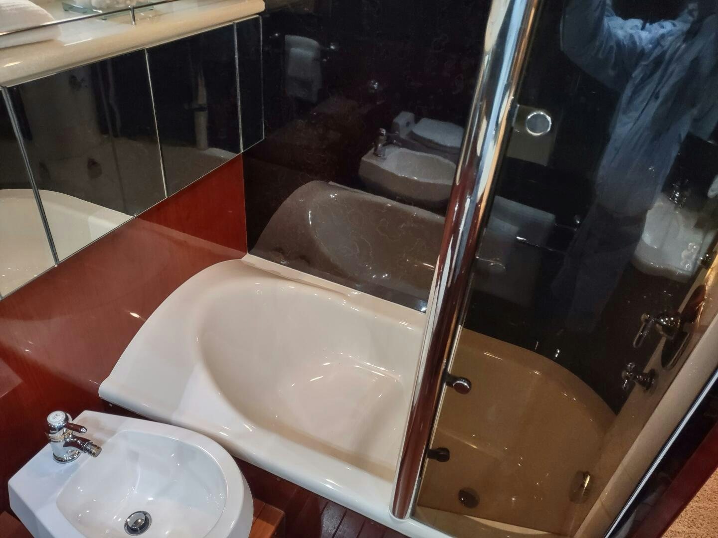 a bathroom with a sink and a mirror aboard F66 Yacht for Sale