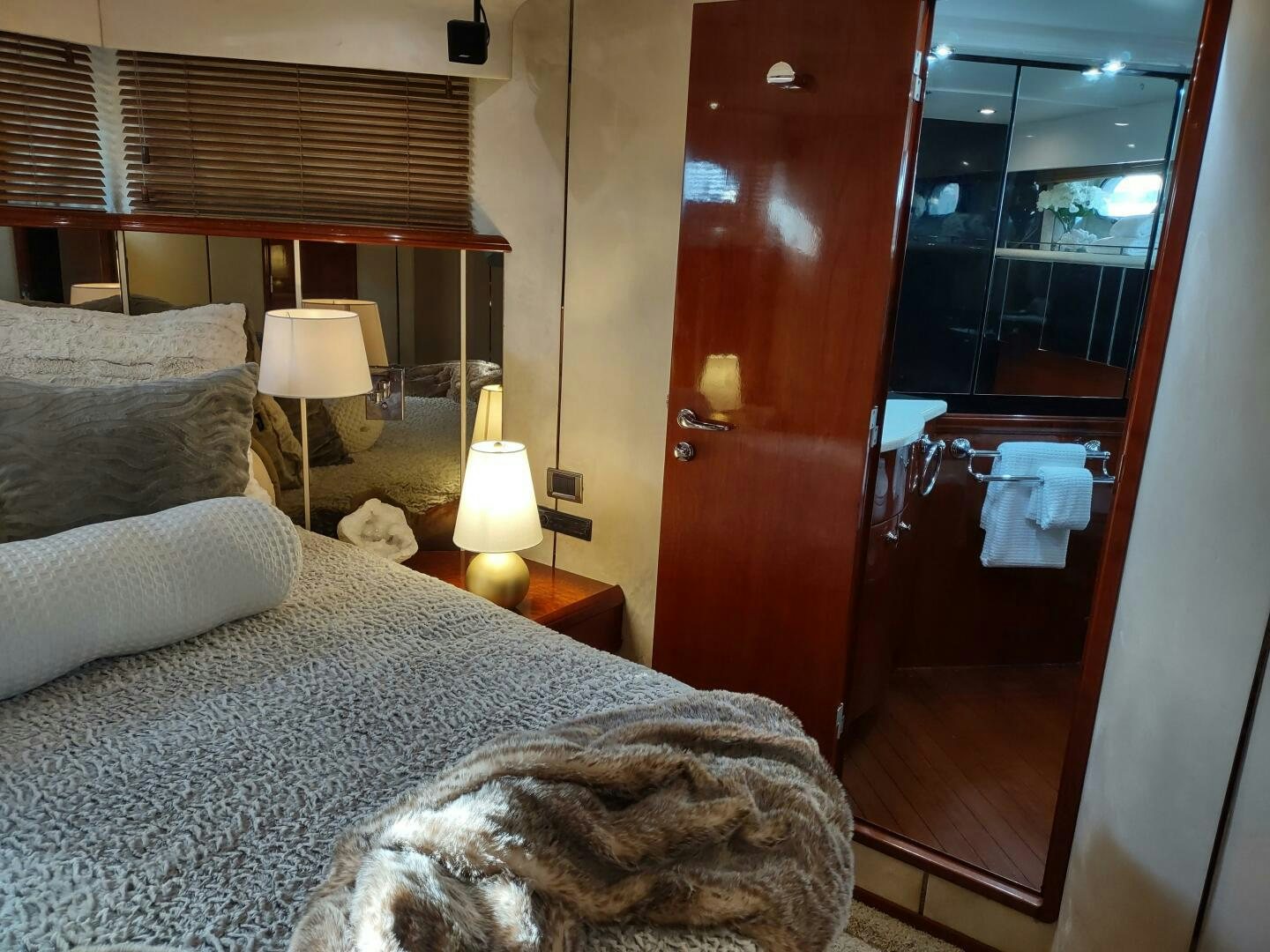 a bedroom with a bed and a mirror aboard F66 Yacht for Sale