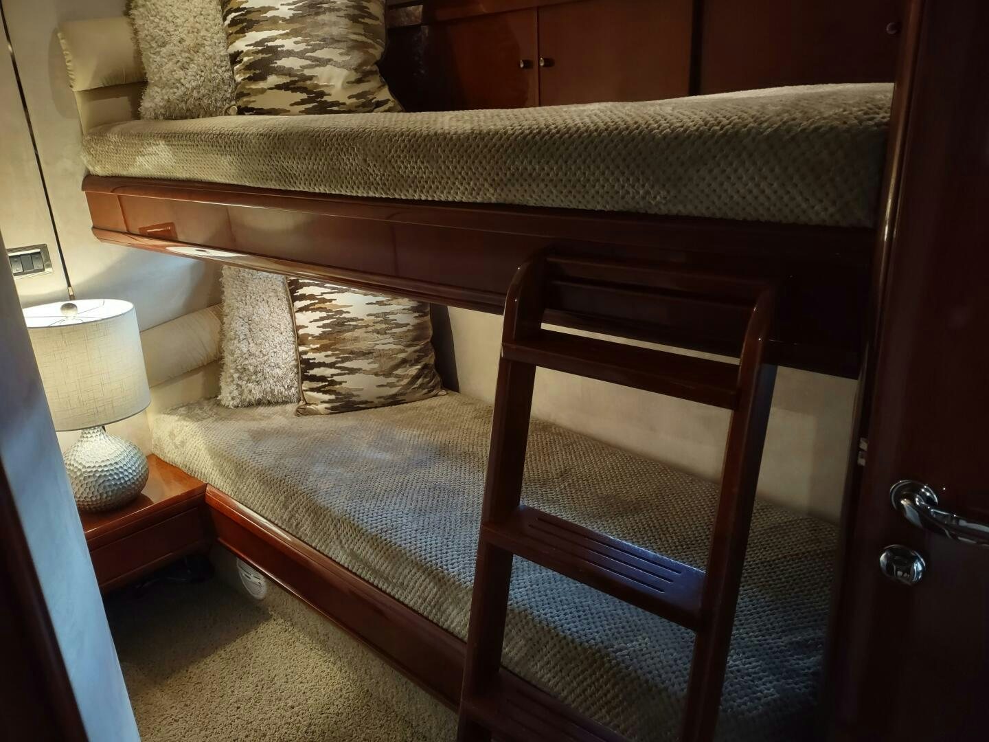 a bed with a wooden frame aboard F66 Yacht for Sale