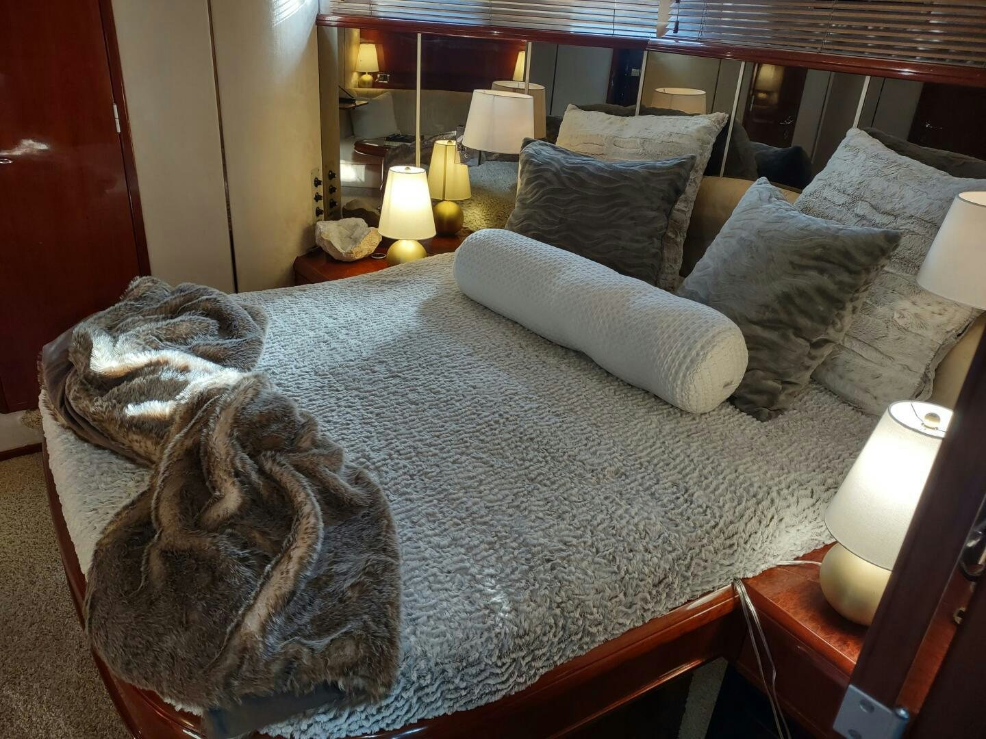 a large bed with a gray blanket aboard F66 Yacht for Sale
