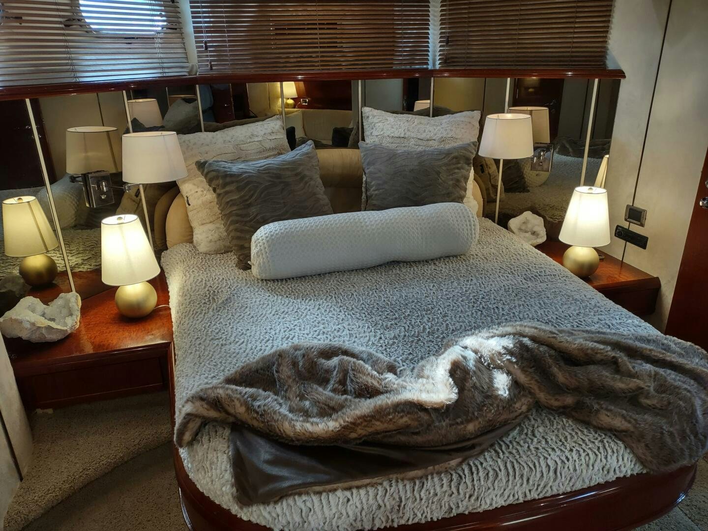 a bed with a large bed spread aboard F66 Yacht for Sale