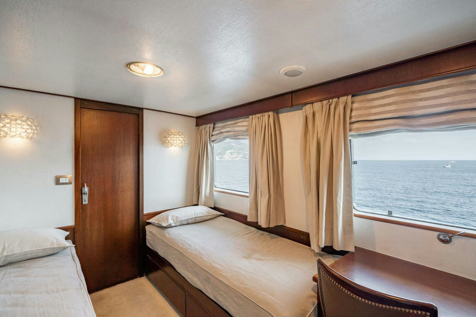 a room with a bed and a window aboard BLUEMAR II Yacht for Sale