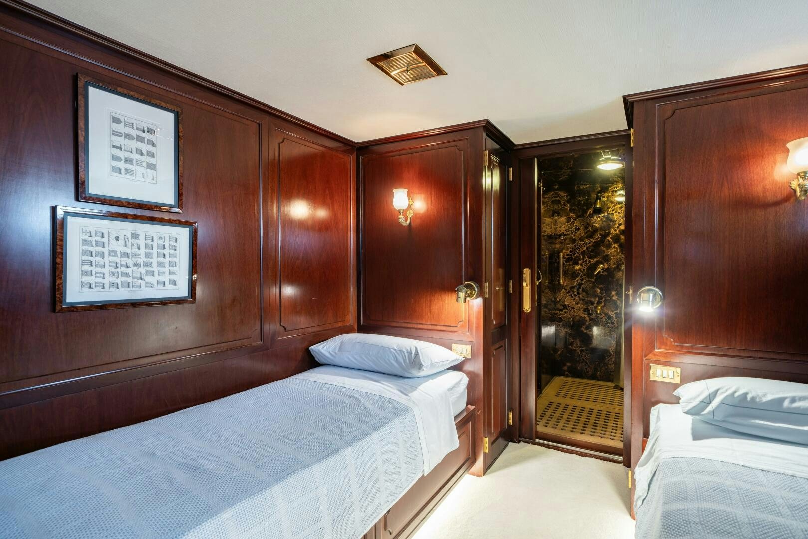 a room with a bed and a wood wall aboard BLUEMAR II Yacht for Sale