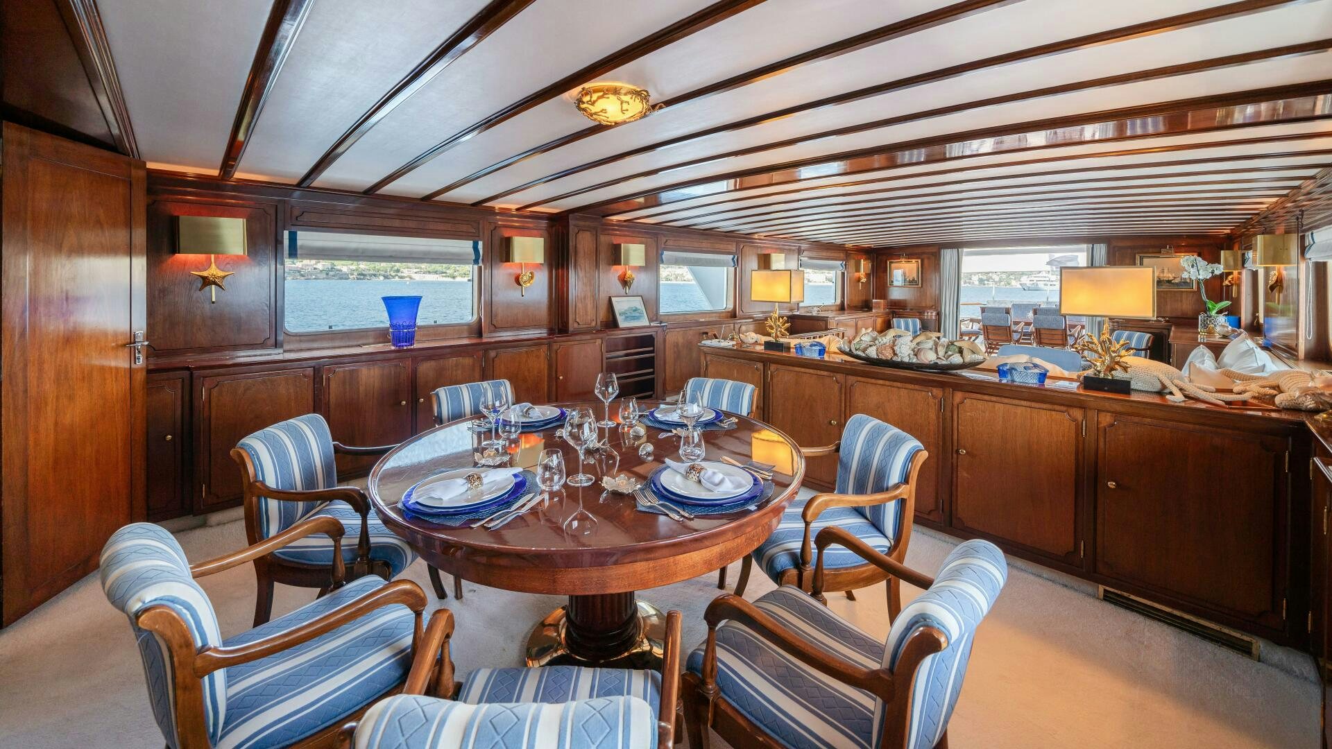 a large kitchen with a dining table aboard BLUEMAR II Yacht for Sale