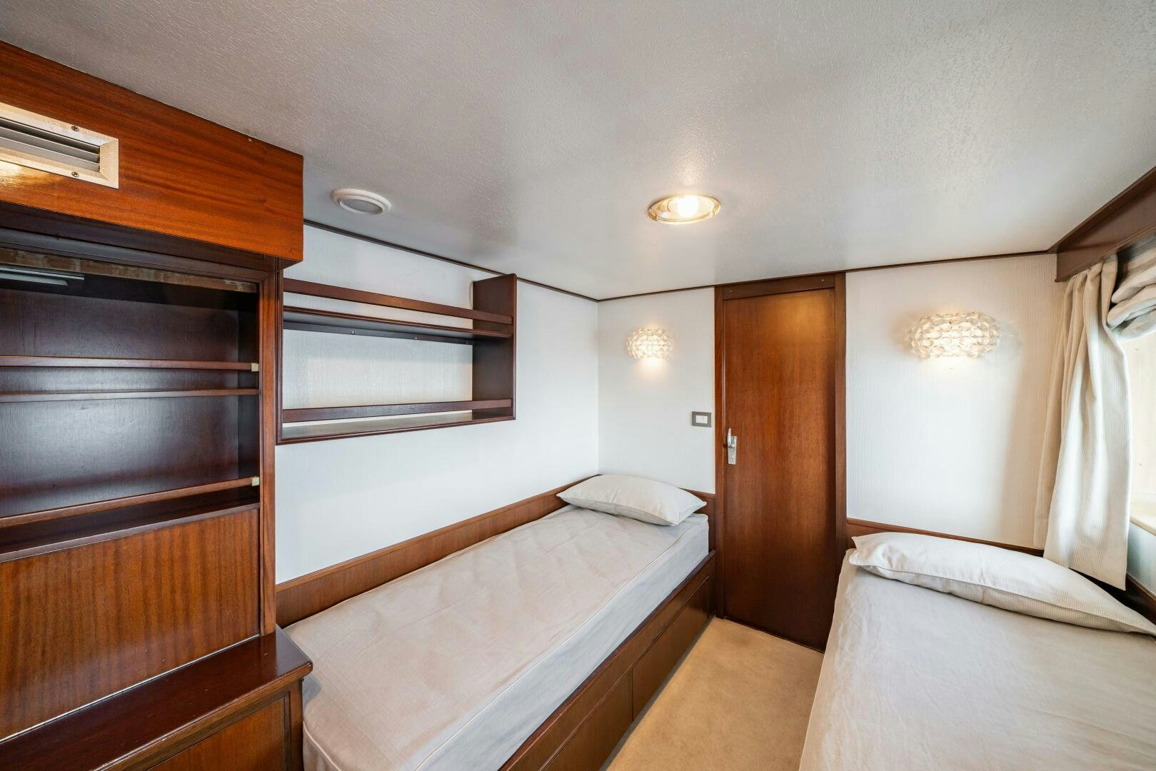 a room with a bed and a closet aboard BLUEMAR II Yacht for Sale