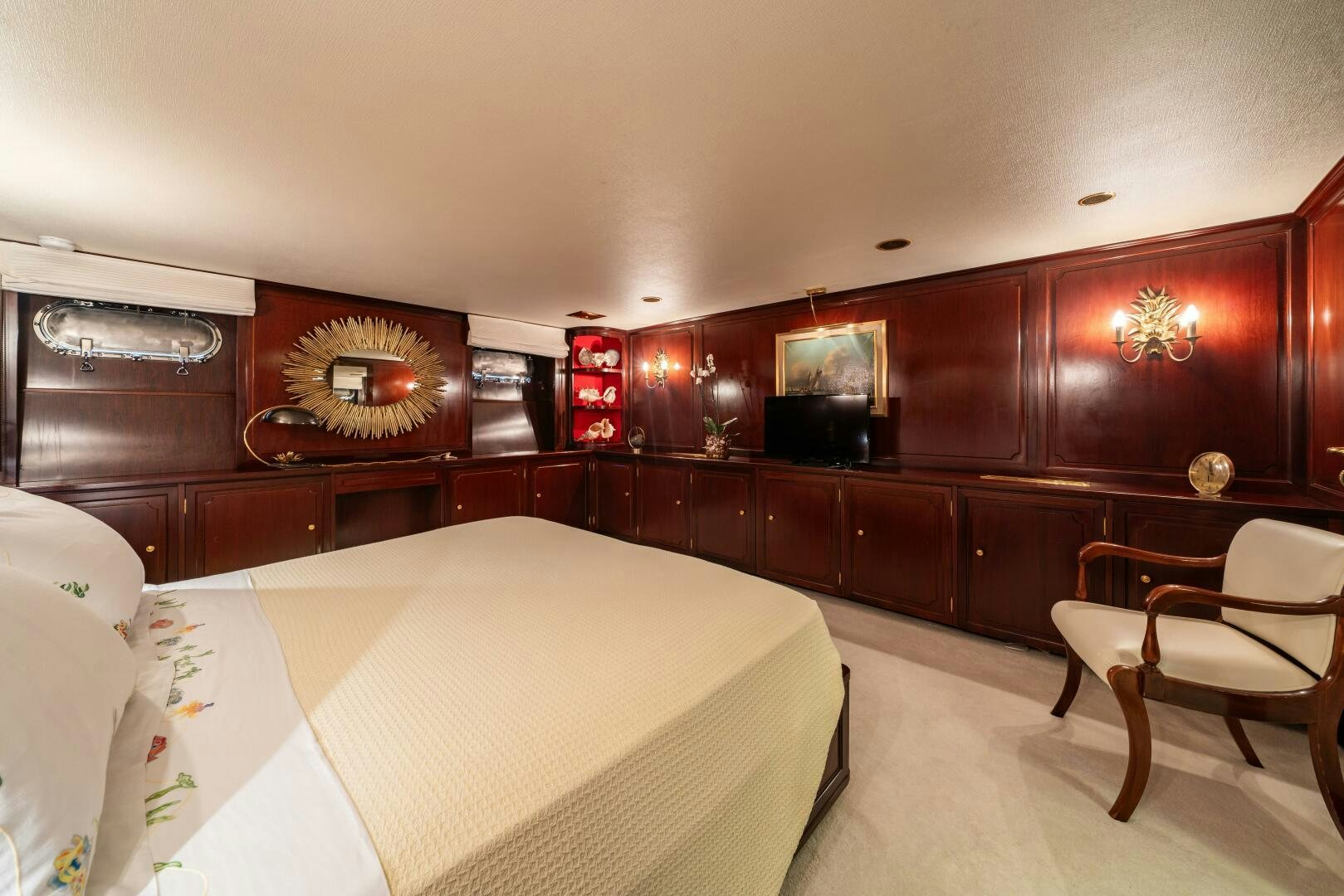 a room with a bed and a chair aboard BLUEMAR II Yacht for Sale