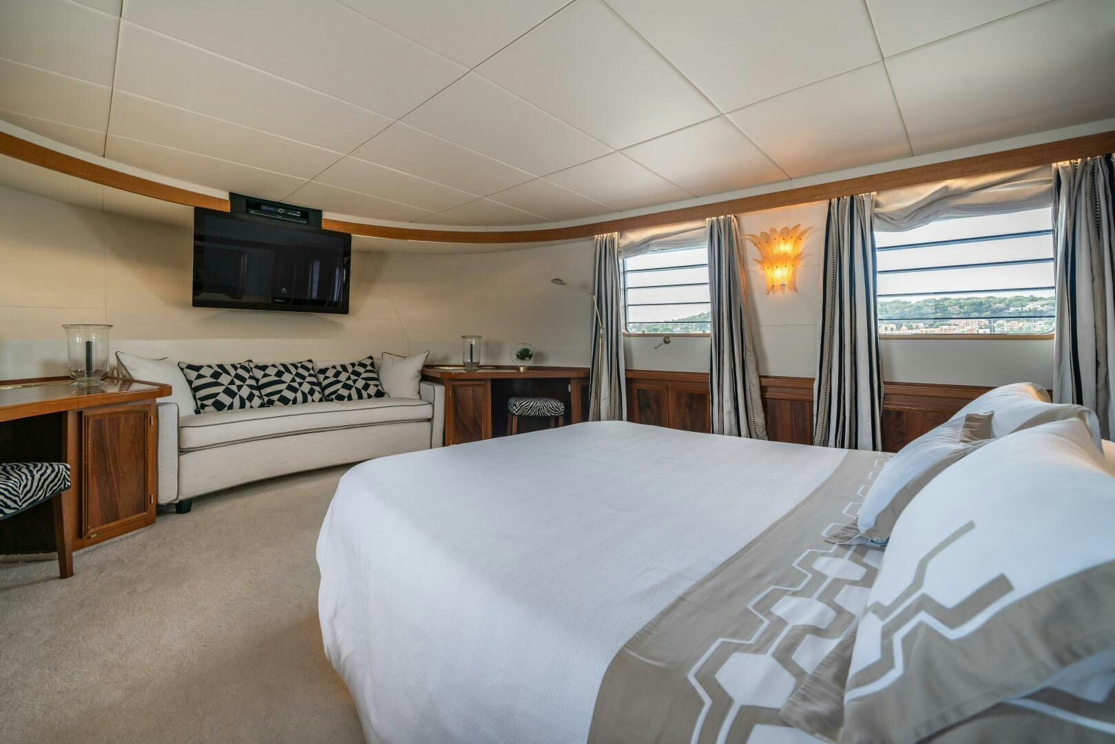 a bedroom with a bed and a television aboard BLUEMAR II Yacht for Sale