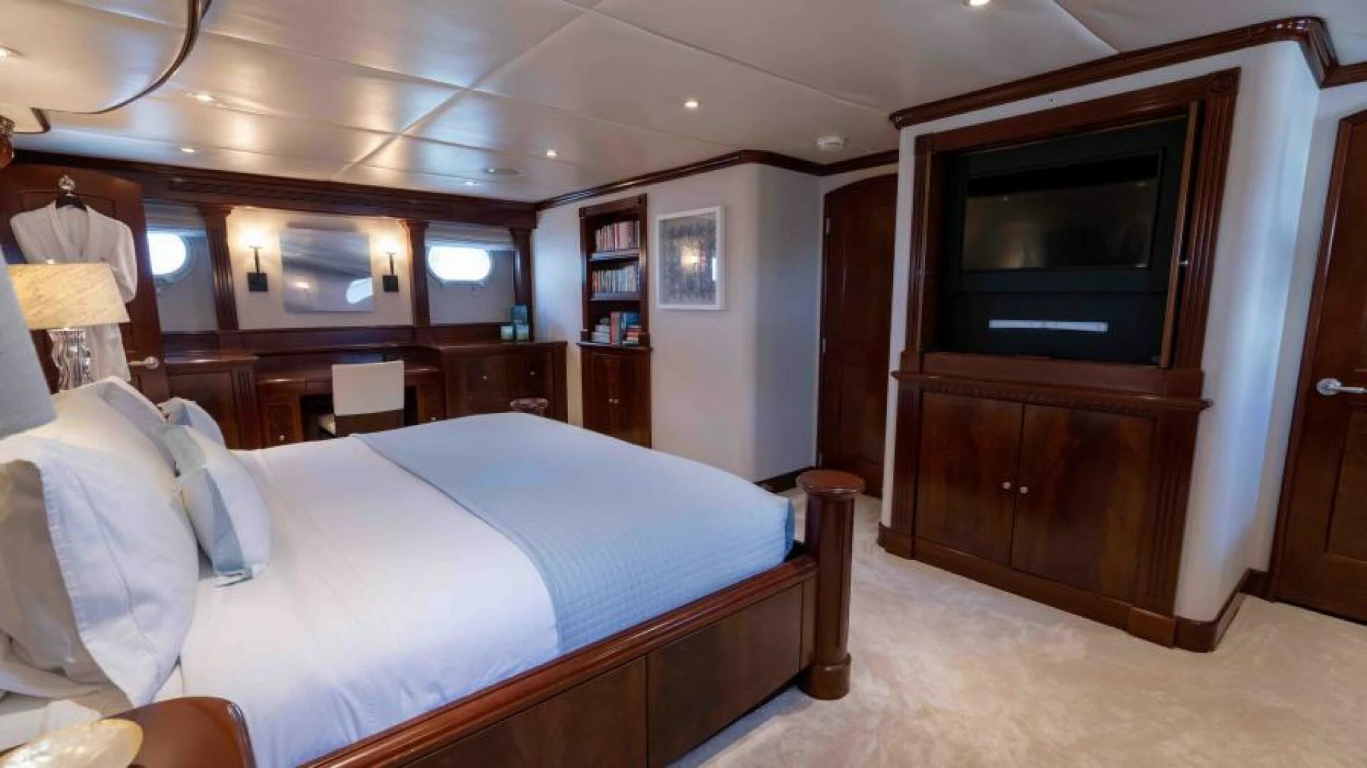 a room with a bed and a television aboard ODIN Yacht for Sale