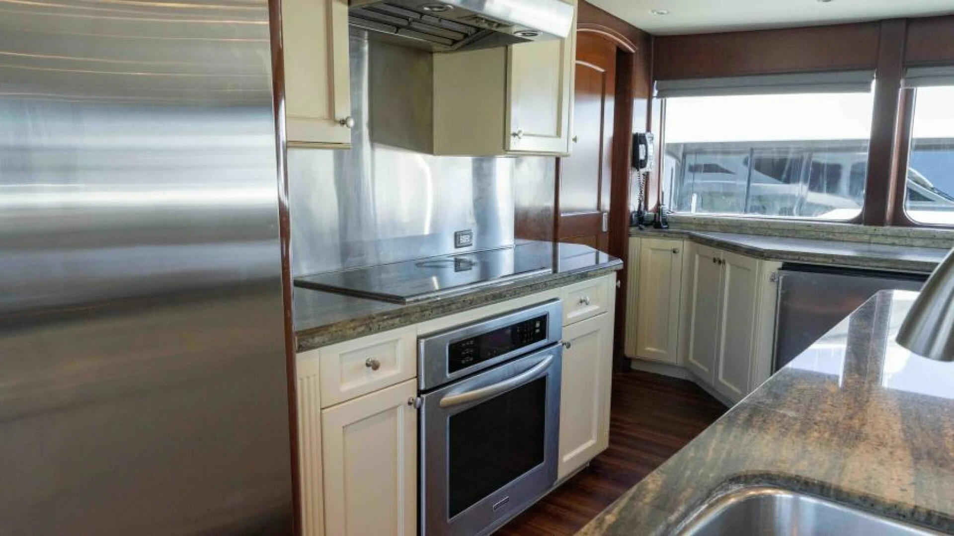 a kitchen with a stove and cabinets aboard ODIN Yacht for Sale