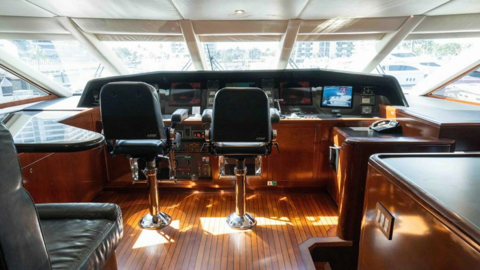 inside of a vehicle with chairs and desks aboard ODIN Yacht for Sale