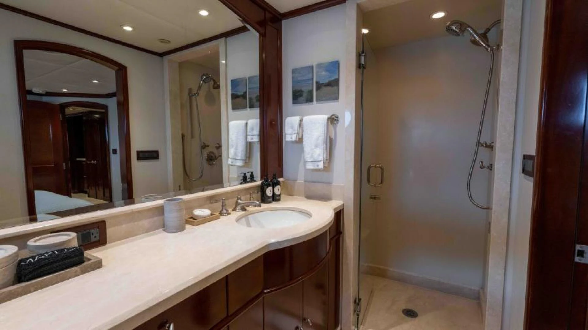 a bathroom with a countertop sink and a shower unit aboard ODIN Yacht for Sale