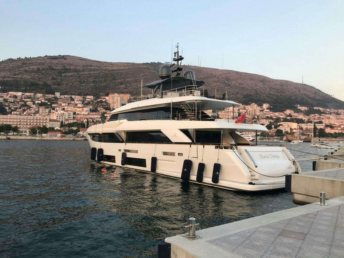 a boat docked at a pier aboard MARIA THERESA Yacht for Sale