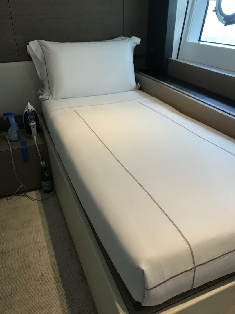 a bed with a white pillow aboard MARIA THERESA Yacht for Sale