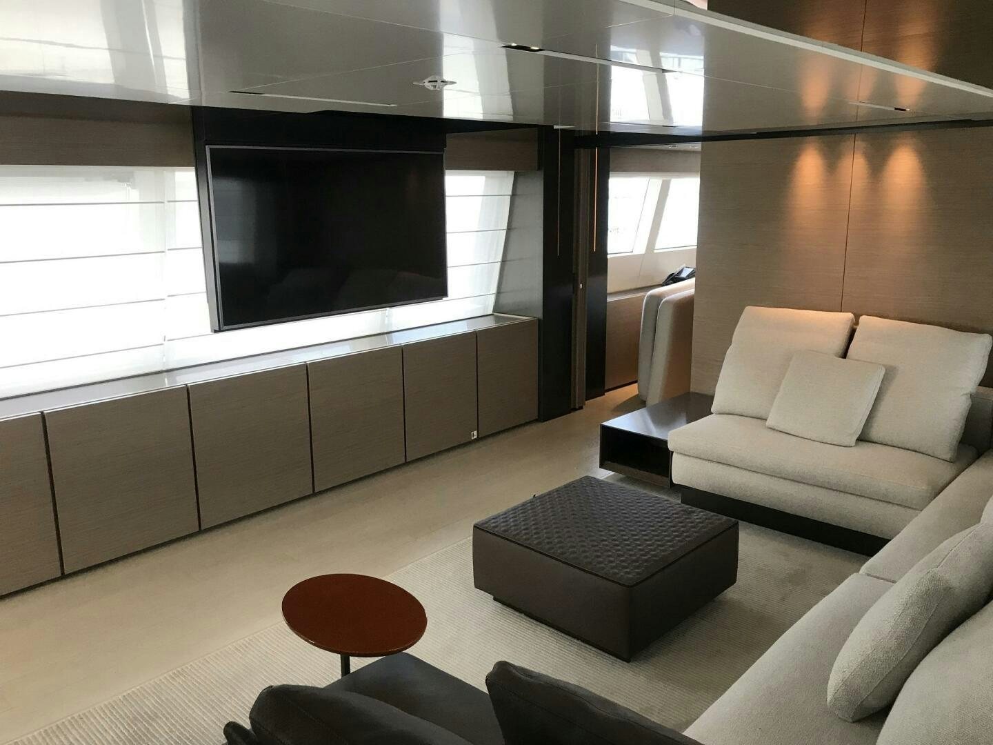 a room with a couch and a tv aboard MARIA THERESA Yacht for Sale