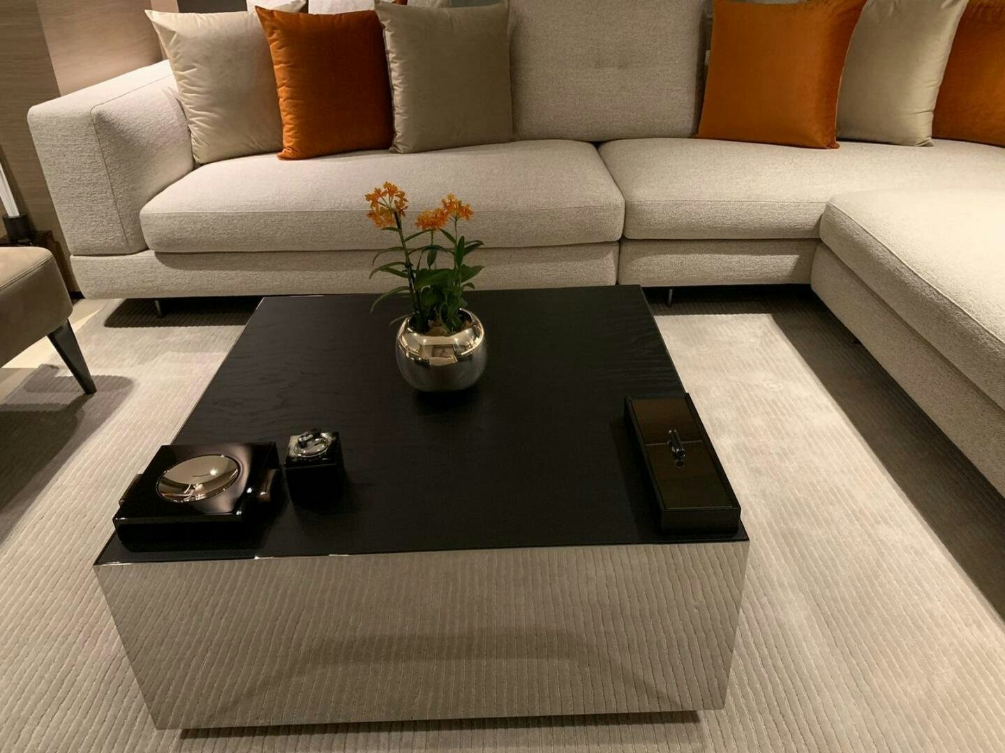 a coffee table with a vase of flowers on it aboard MARIA THERESA Yacht for Sale