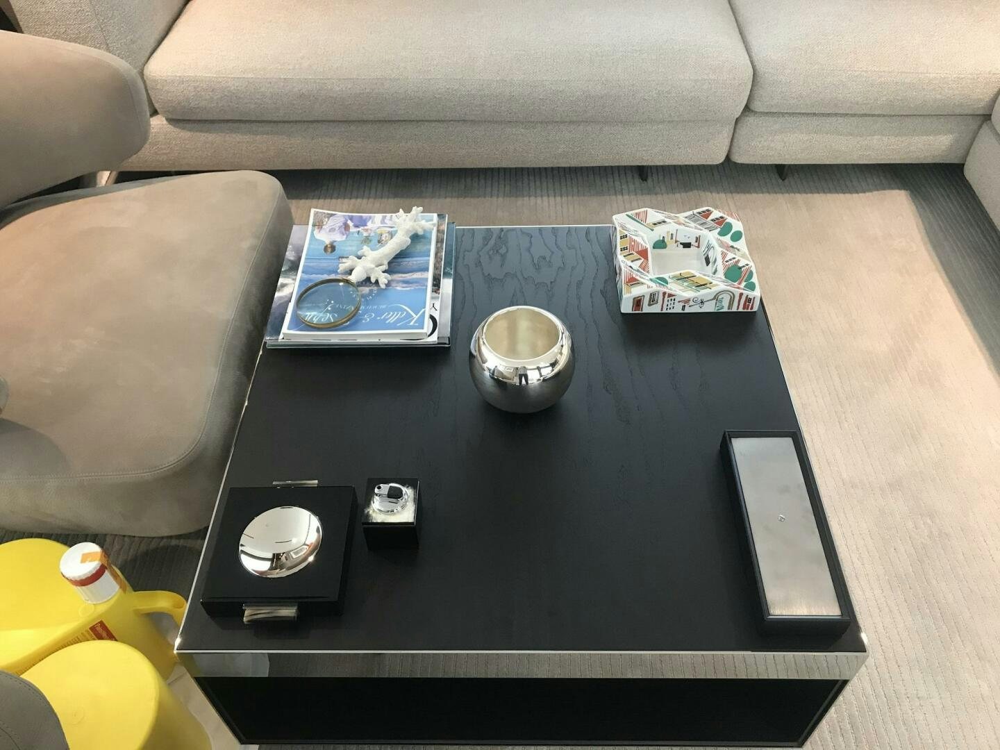 a black table with a black coffee mug and a white box with a black lid on it and aboard MARIA THERESA Yacht for Sale