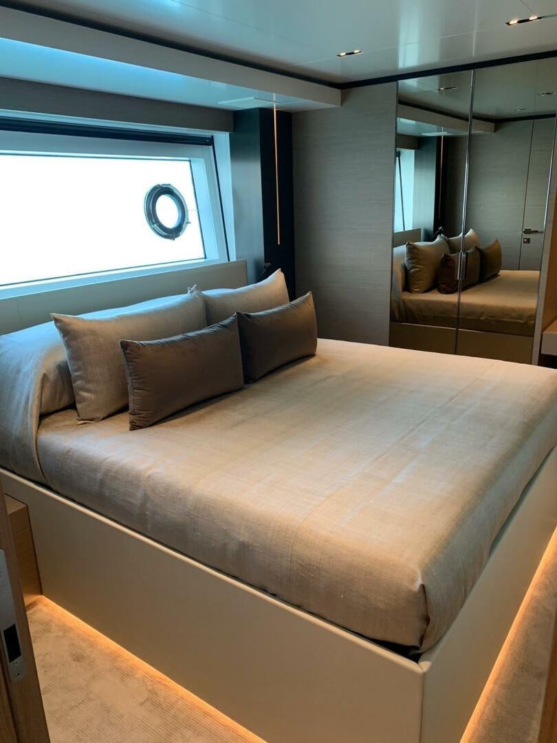a bed with a couch and a window aboard MARIA THERESA Yacht for Sale
